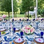 pink-roses-tablescape-arrangement-blue-white-chinoiserie-pagoda-bamboo-flatware-rattan-round-placemats