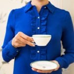 a Beaumont Etiquette-holding-tea-cup-saucer-vertical-myka-meier