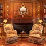wood-paneled-library-fireplace-chairs-books-renzo-mongiardino-1-sutton-place-sothebys
