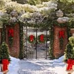 red-brick-iron-gate-wreaths-christmas-red-bows-snow-entrance