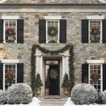 stone-house-traditional-home-wreaths-on-windows-garland
