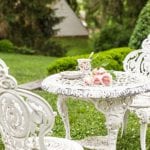 outdoor-tea-time-pink-roses-garden-wrought-iron-table-chairs