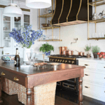 white-marble-kitchen-la-cornue-oven-range-stove-wood-table-island-copper-pots
