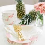 palm-beach-lately-flamingo-bowls-gold-flatware-pink-white-striped-plates-pineapples