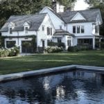 black-garage-doors-dormers-white-sideboard-house-swimming-pool-backyard-back-yard-entrance-landscaping