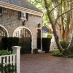 black-painted-garage-doors-red-brick-pavement-driveway-white-picket-fence-shingle-style