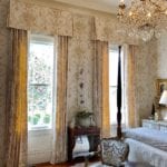 beige-toile-bedroom-crystal-chandelier-canopy-bed