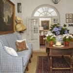 entry-hall-French-high-back-canapé-oil-paintings-portraits-sisal-rug-stark-persian-rug-on-top-buffalo-check-plaid-gingham
