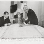 Luis Rey, Betty Sherrill, and John Drews looking at plans for John F. Kennedy Library