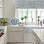 blue-and-white-kitchen-topiaries-roman-shade-plates-farmhouse-sink-marble