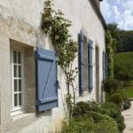putty-walls-blue-shutters-climbing-rose-french-village-home