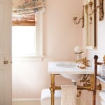 shell-pink-painted-bathroom-brass-sink-fixtures-floral-chintz-persian-rug