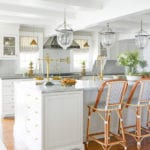 white-marble-kitchen-classic-style-bell-jars-pendants-french-bistro-chairs-brass-accents