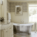 Drummonds tub has a bathmat made by Nancy Stanley Waud Fine Linens. A wallpaper by Watts of Westminster