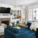 blaire-murfree-family-room-blue-navy-velvet-settee-brick-fireplace-bookcase-styling