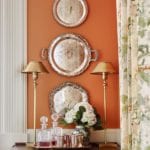 silver-platters-hanging-on-wall-bar-mint-julep-cups-orange-painted-walls