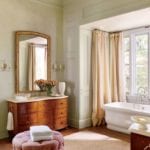 suzanne-kasler-bathroom-antique-sink-waterworks-freestanding-tub-bathtub-hickory-chair-poof-ottoman