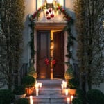 bettie-bearden-pardee-christmas-house-decorated-holidays-candles-on-front-porch-steps-garland-around-front-door-decor