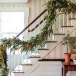 historic-19th-century-home-decorated-for-christmas-holidays-cathernie-olasky-max-sinsteden-entrance-stairs-staircase-garland-dried-oranges