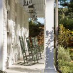 southern-style-home-front-porch-rocking-chairs-columns-white-siding
