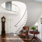 brockschmidt and coleman grandmillennial spiral staircase sweeping foyer entry