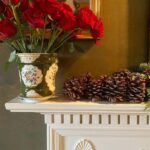 aerin-lauder-red-roses-christmas-holiday-mantel-pinecones-garland-instagram
