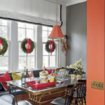 breakfast-room-nook-decorated-for-christmas-wreaths-on-windows-red-bows