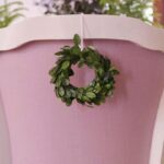 christian-ladd-preserved-boxwood-wreath-on-back-dining-chair-purple-christmas-holiday
