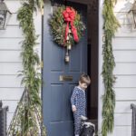clary-bosbyshell-christmas-door-decorations-wreath-bells-greenery-garland-red-bow-king-charles-cavalier