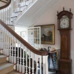 pink-ground-farrow-and-ball-curved-staircase-english-entrance-hall-equestrian-art-long-case-clock