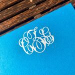Dulles Designs – white monogram on Caribbean blue paper